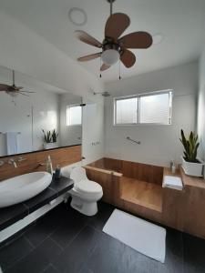 a bathroom with a tub and a toilet and a sink at L`aurora Hotel Boutique in Yopal