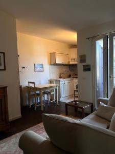 a living room and kitchen with a couch and a table at SUN Holiday in Salò