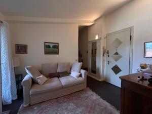a living room with a white couch in a room at SUN Holiday in Salò