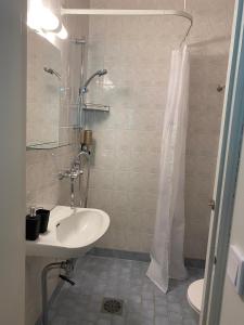 a bathroom with a sink and a shower at Trivsam 1 a in Mariehamn