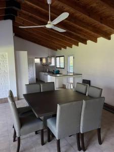 un tavolo da pranzo con sedie e un ventilatore a soffitto di Casa Los Ciruelos - Chacras de Coria a Mayor Drumond