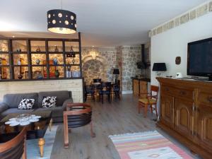 a living room with a couch and a table at Rahoni Park & Suites in Dhërmi