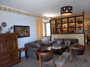 a living room with a couch and a table at Rahoni Park & Suites in Dhërmi