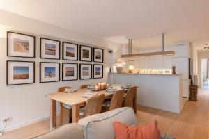 a kitchen and dining room with a table and chairs at Huswell - Apartment on top location in Knokke with parking in Knokke-Heist +31 photos