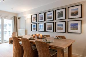 a dining room with a wooden table and chairs at Huswell - Apartment on top location in Knokke with parking in Knokke-Heist