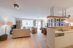 a kitchen and living room with a couch and a table at Huswell - Apartment on top location in Knokke with parking in Knokke-Heist