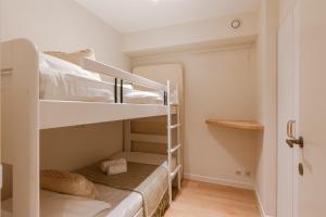 a small room with two bunk beds in it at Huswell - Apartment on top location in Knokke with parking in Knokke-Heist