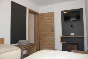 a bedroom with a door and a bed and a fireplace at Mesnerwirt in Neukirchen am Teisenberg