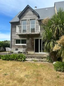 a house with two chairs in front of it at L escapade du Cap in Barneville-Carteret