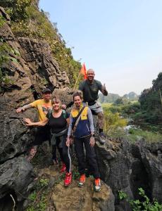 a group of people standing on a rocky mountain at Thung Sen Tam Coc Chalets in Ninh Binh