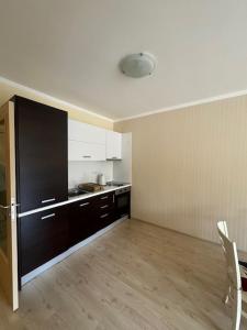 a room with a kitchen with a table and chairs at Charming Two-Bedroom Apartment in Villa Roma in Burgas City