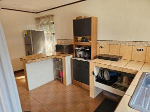 a kitchen with a refrigerator and a counter top at Casa Naboo in Santa Cruz