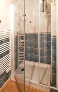 a shower with a glass door in a bathroom at Maison de 4 chambres avec vue sur le lac et terrasse amenagee a Saint Genes Champespe in Saint-Genès-Champespe