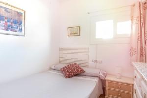 two beds in a small room with a window at Lovely Mediterranean Penthouse in Costa Brava in Empuriabrava