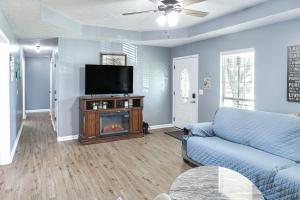 a living room with a couch and a television at Murfreesboro Family Home with Pool and Backyard! in Murfreesboro