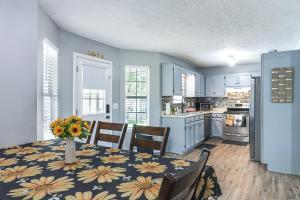 a kitchen with a table with a vase of flowers on it at Murfreesboro Family Home with Pool and Backyard! in Murfreesboro