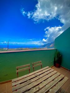 un banco de madera sentado en un patio con vistas al agua en ApKanariooo, en La Frontera