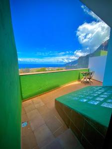 a balcony with a table and a view of the ocean at ApKanariooo in Frontera