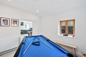 a blue pool table in a living room at Flour Mill House - Pitkerro Mill in Dundee +25 photos