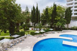 an overhead view of the pool at a hotel with chairs and umbrellas at Kenzi Solazur in Tangier