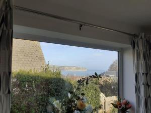 a window in a room with a view of the ocean at Marlow in Swanage