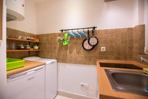 a small kitchen with a sink and a dishwasher at eazZynight Center Apartment in Zagreb