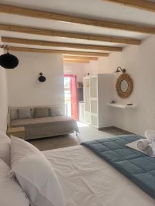 a large bedroom with a bed and a kitchen at Studios Venetsanos in Koufonisia