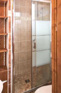 a shower with a glass door in a bathroom at Studio a La Plagne Tarentaise a 300 m des pistes avec balcon amenage et wifi in La Plagne Tarentaise