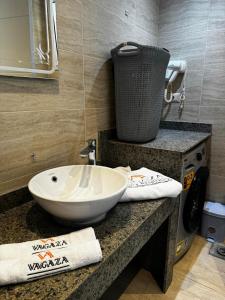 a bathroom with a white sink on a counter at Deluxe Cabana with Vagaza signature in Hacienda Bay North Coast in El Alamein