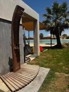 an open door to a house with a pool at Deluxe Cabana with Vagaza signature in Hacienda Bay North Coast in El Alamein