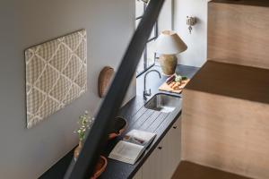a small kitchen with a sink and a counter top at Guesthouse Aubrey - Charming Cottage in the Heart of Bruges in Bruges +29 photos