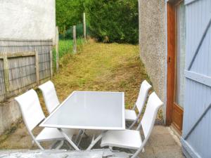 a white table and chairs on a patio at Maison de 3 chambres avec jardin clos a Aragnouet a 6 km des pistes in Aragnouet