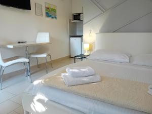 a bedroom with a bed with towels on it at Apartments Angie in Zadar