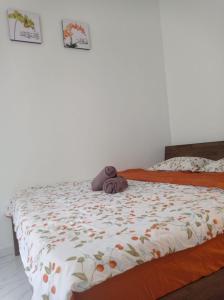 a stuffed teddy bear laying on a bed at D' Tanjung Homestay-Orked in Pekan +6 photos