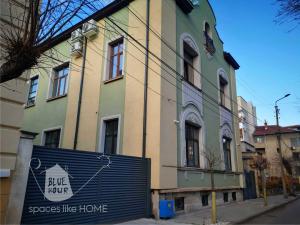 a building with a blue hope sign in front of it at Пространства за гости Синият час - апартамент The Glass Moon in Ruse