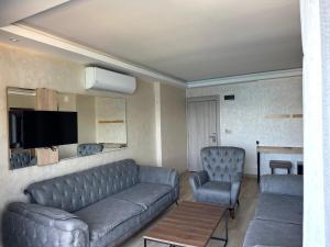 a living room with a couch and a chair at point beach hotel in Marmaris