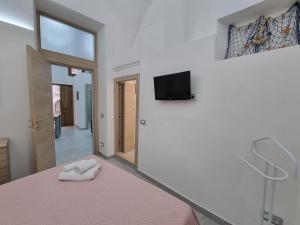 a bedroom with a bed and a tv on a wall at Torremare in Formia +2 photos