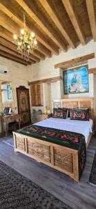 a bedroom with a large bed and a chandelier at nahrin hote & art in Sanlıurfa