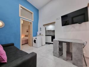 a living room with a couch and a tv on a wall at Torremare in Formia