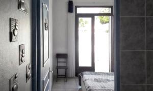 a room with a door and a doorway with a bed at Maison de 2 chambres a l'Etang Sale les Bains a 30 m de la plage avec jardin clos et wifi in Étang-Salé les Bains