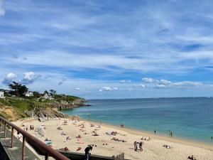 a beach with people on the sand and the water at PENTY Tregana in Loc-Maria-Plouzané
