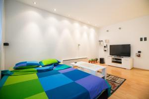 a bedroom with a bed and a flat screen tv at eazZynight Center Apartment in Zagreb