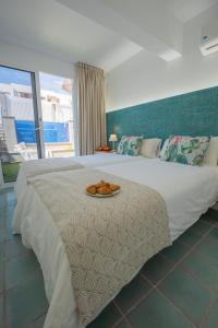 a large white bed with a plate of food on it at Villa Galatea - San Agustín in San Agustin +42 photos