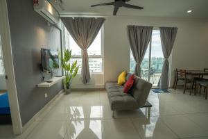 a living room with a couch and a tv at Georgetown Seaview MansionOne @Penang in George Town