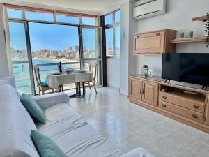 a living room with a couch and a flat screen tv at Apartamentos Horizonte Estudio (8º-801) in Calpe