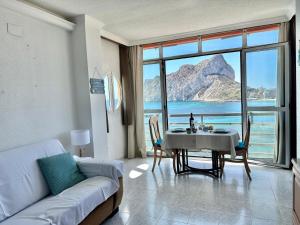 a living room with a table with a view of the ocean at Apartamentos Horizonte Estudio (8º-801) in Calpe