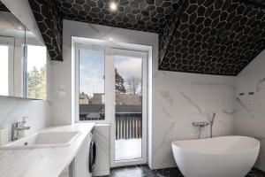 a bathroom with a sink and a toilet and a window at Posti villa 2 in Pärnu +18 photos