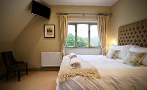 a bedroom with a large bed and a window at Blacknest Golf and Country Club in Alton