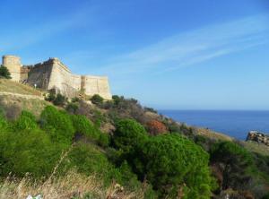 a castle on top of a hill with the ocean at Seaview Condo Tabarka in Tabarka