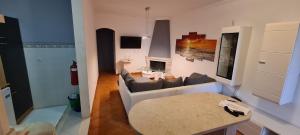 a living room with a couch and a fireplace at Vila Vistazul in Pataias